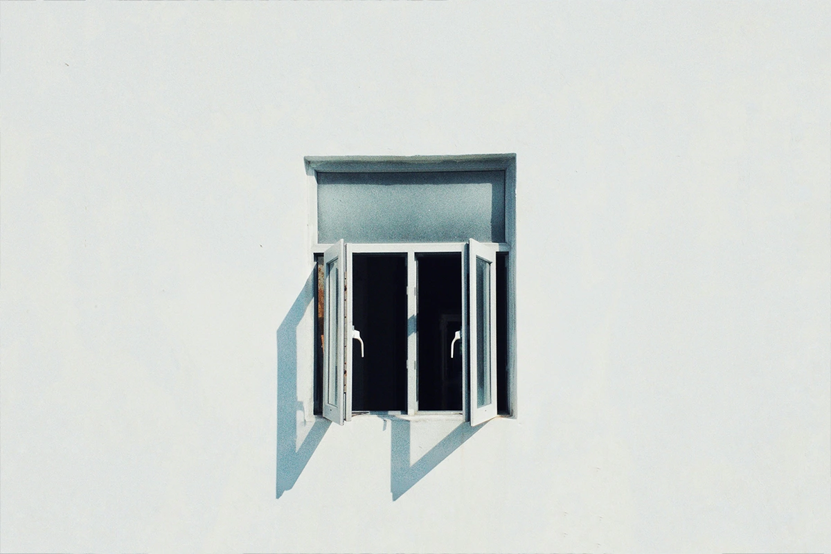 Light falling through a window onto a white wall.